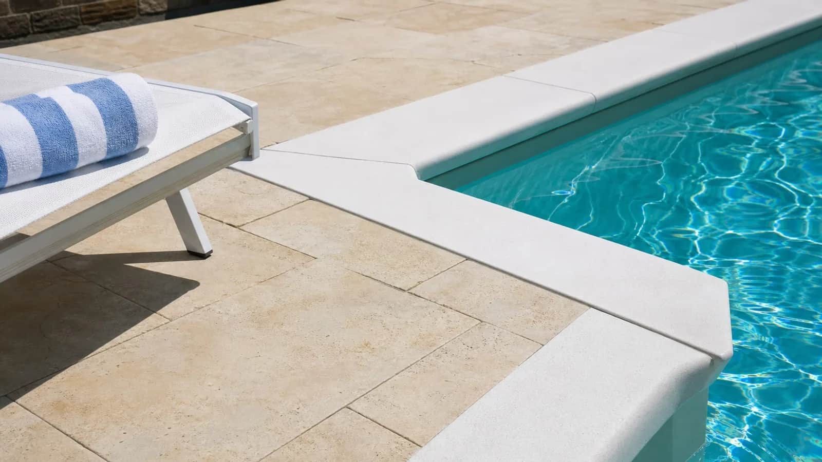 Light paver pool deck and clear water in Colorado sunlight