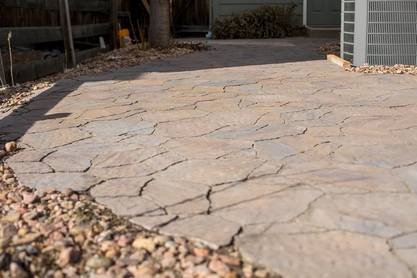 Custom paver patio with built-in fire feature and seating area in Colorado