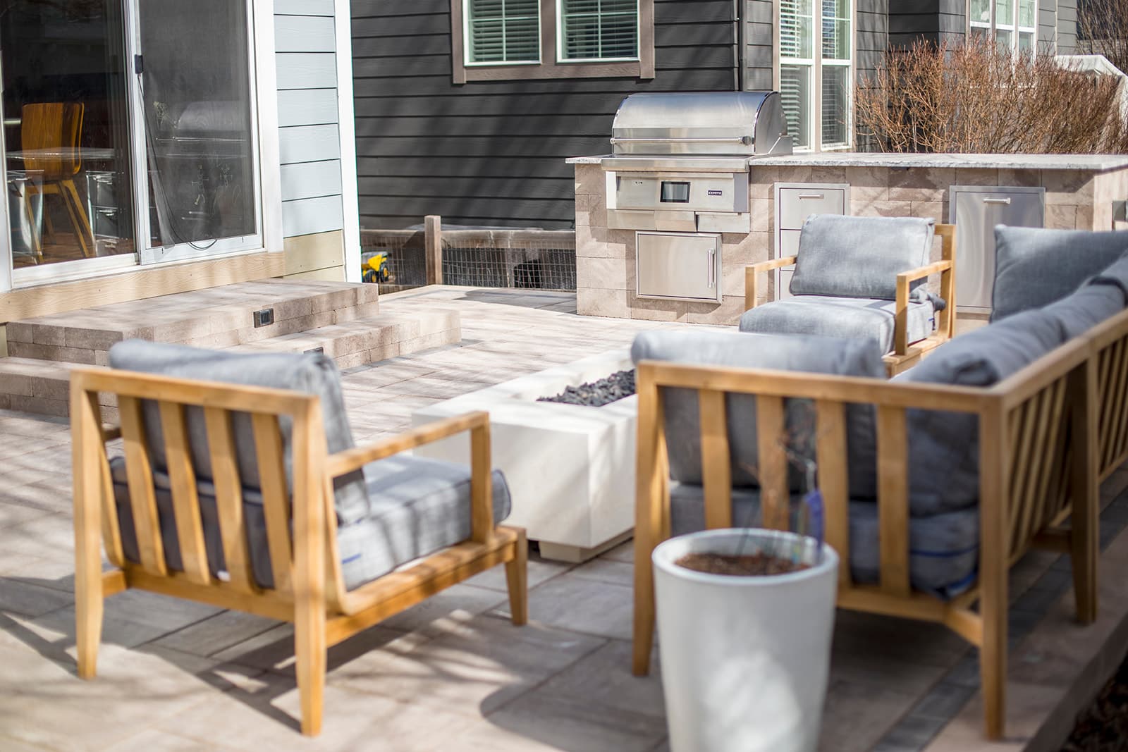 Custom hardscape design with stone planters and paver driveway in Erie, Colorado