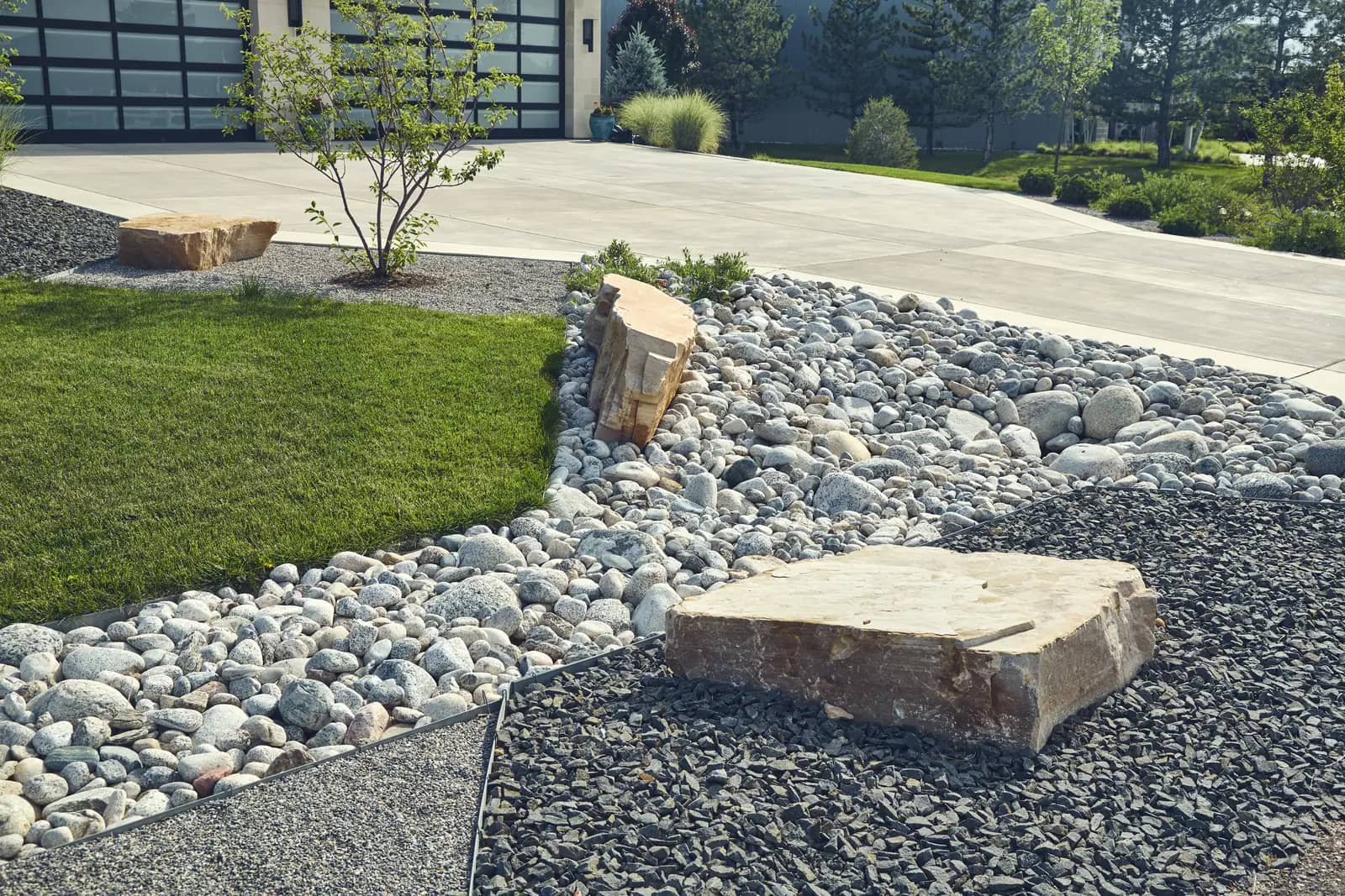 Detail of river rock, boulder slab, and steel edging materials