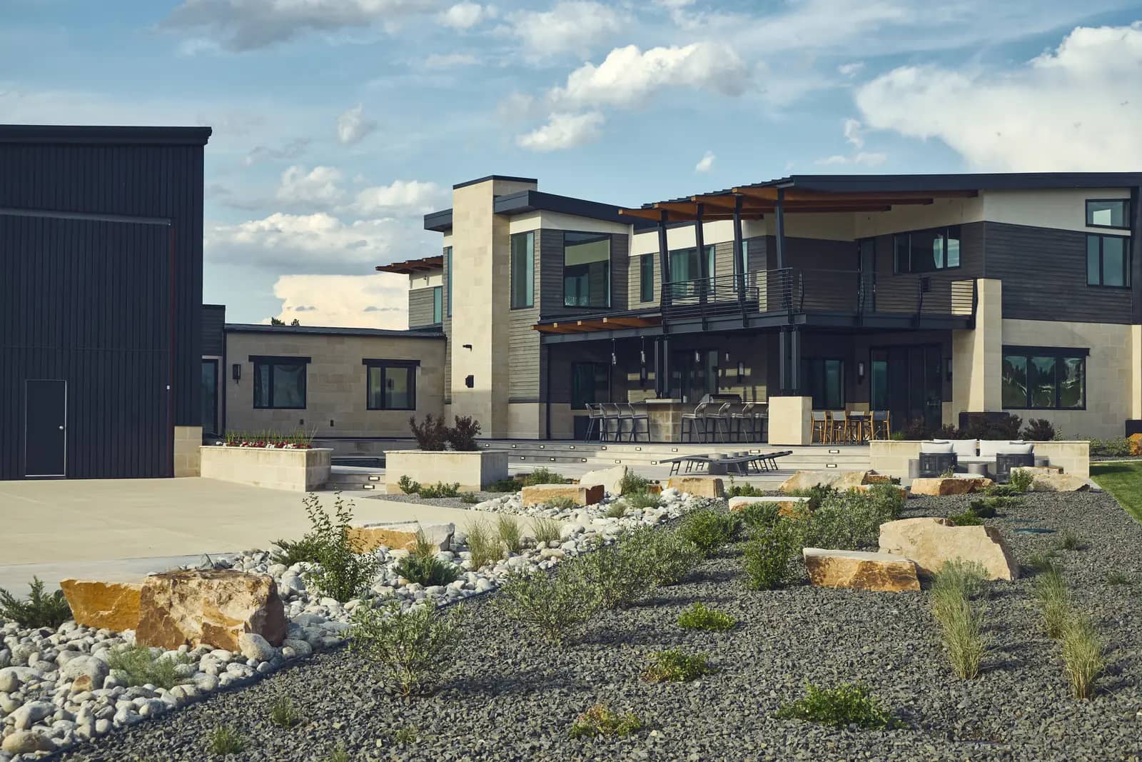 Terraced backyard with boulder retaining and gravel beds during the build